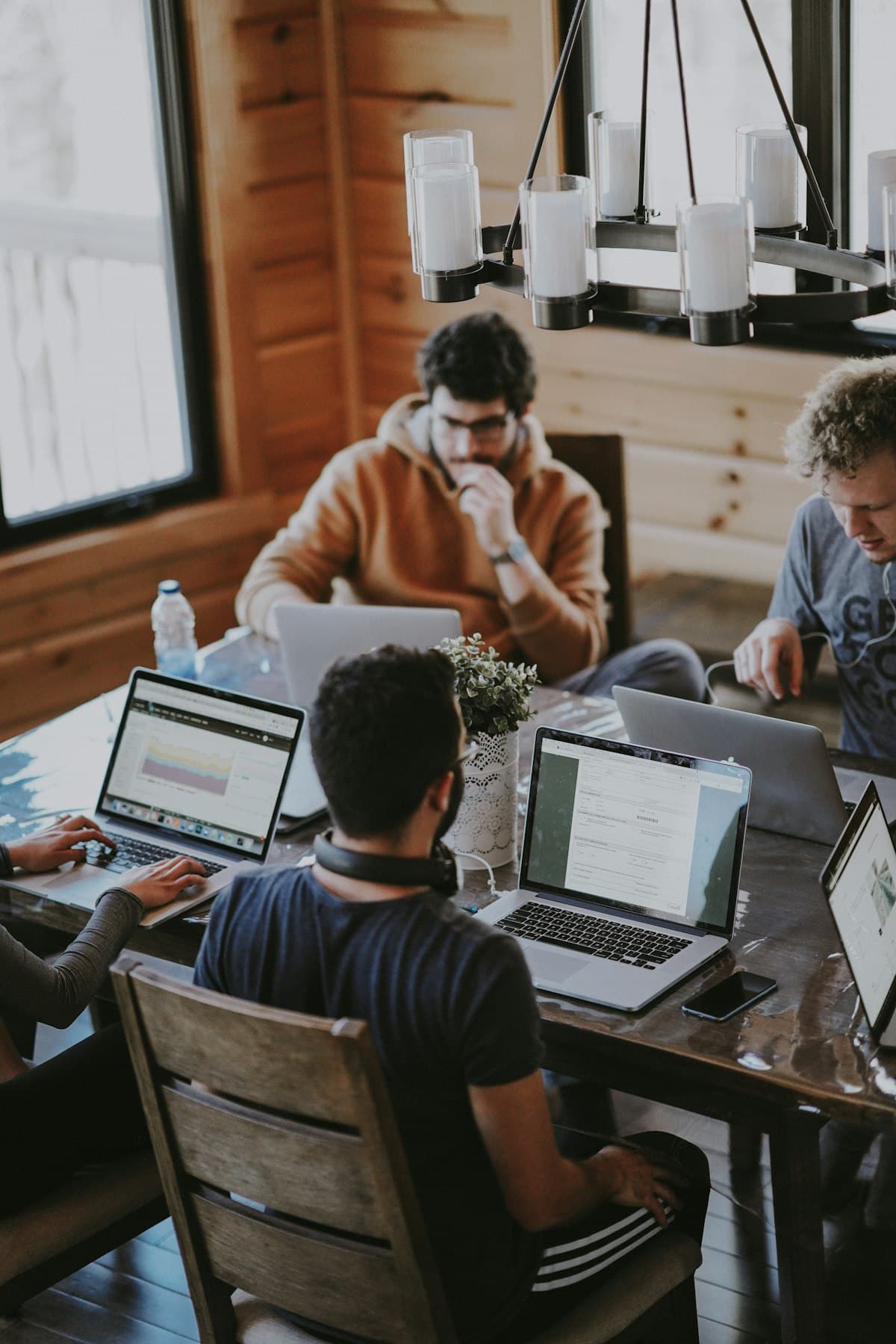 A team working together around laptops in a bright workspace